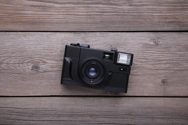 Vintage camera on grey wooden background. Old photo camera on grey wooden background