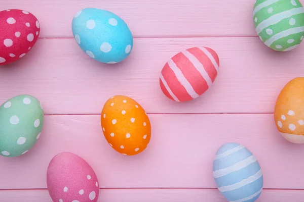 Colorful easter eggs on a pink background