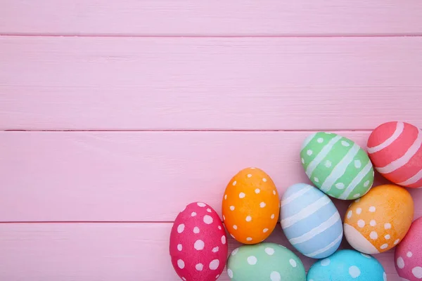 Colorful easter eggs on a pink background