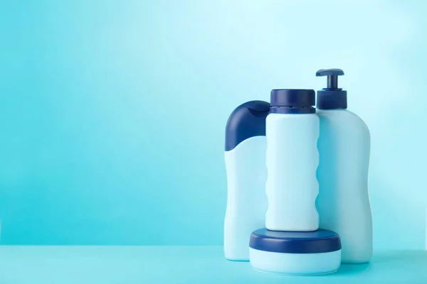 Blue cosmetic bottles on blue background. Set of bottles