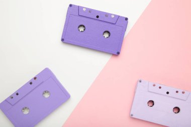 Pembe ve beyaz arka planda eski renkli kasetler. Müzik günü, üst görünüm