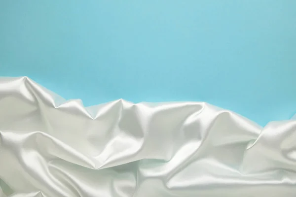 White Satin Fabric Blue Background Top View — Stock Photo, Image