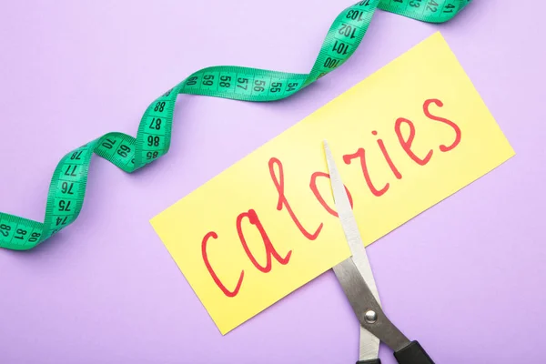 Card with the word calories. Cutting calories. Cutting calories. Top view