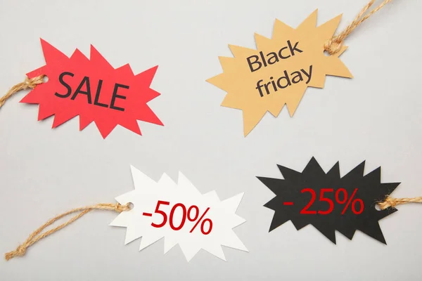 Sale tags with percent and incription sale on grey background. Black friday. Top view