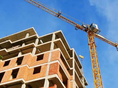 Turna ve mavi gökyüzüne karşı bina. İnşaat alanı arka planı