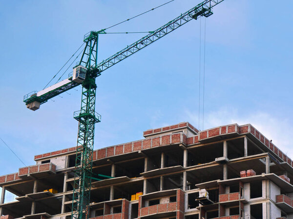 Construction site. Crane near building.