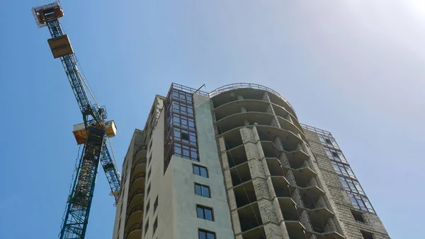 Crane near building. Construction of office building  with two tower crane. Construction site.