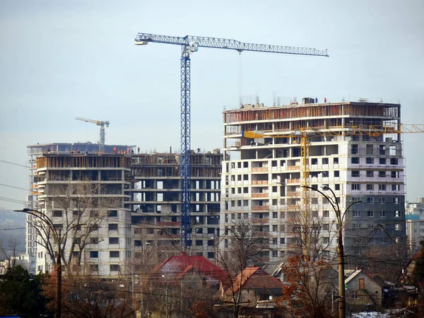 Construction site. Commercial building project. Cranes near buildings