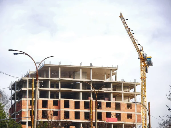 Building under construction. Construction site background. Crane near building