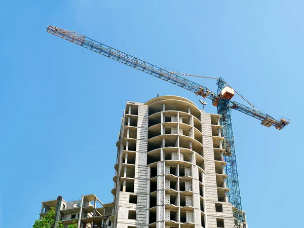 Building site. Construction site.Crane and building against blue sky.