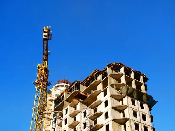 Tower crane and building activity. Construction site background.