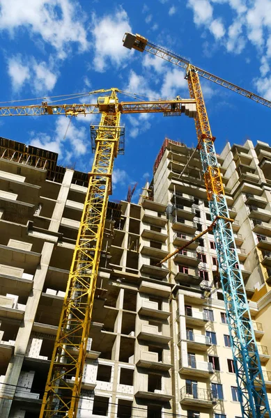 Construction site background. Cranes near buildings. Industrial