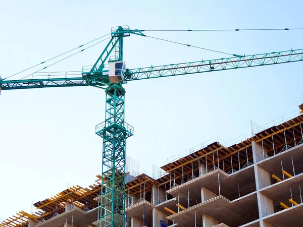 Hoisting crane and building activity.Construction site. Construc