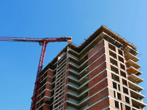 Construction site background. Crane near building. Red brick bui