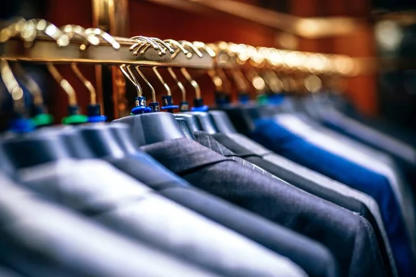 Men's suits on hangers in boutique store