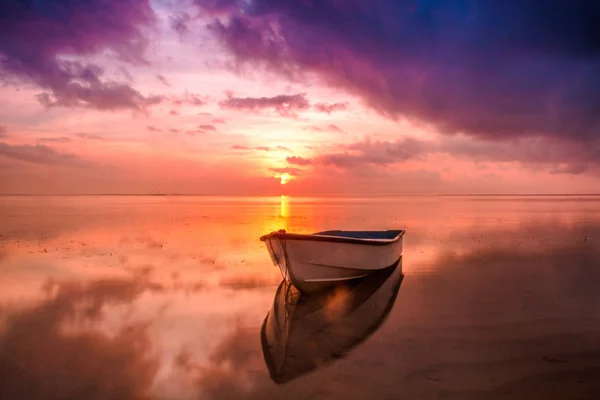 Fishing boat in the sea reflection in the water