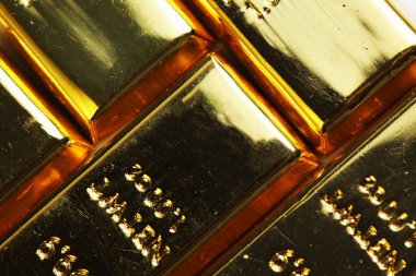 Close up shot of stacked 999.9 pure gold bar ingot on a white background, represented the business, invesment and finance concept idea
