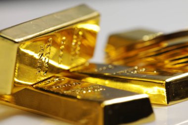 Close up shot of stacked 999.9 pure gold bar ingot on a white background, represented the business, invesment and finance concept idea