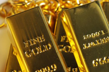 Close up shot of stacked 999.9 pure gold bar ingot on a white background, represented the business, invesment and finance concept idea