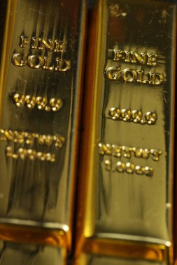 close up shot of stacked 999.9 pure gold bar ingot on a black background, represented the business, invesment and finance concept idea