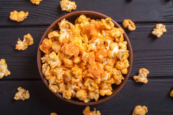 Yellow cheese popcorn in bowl . Snack for cinema