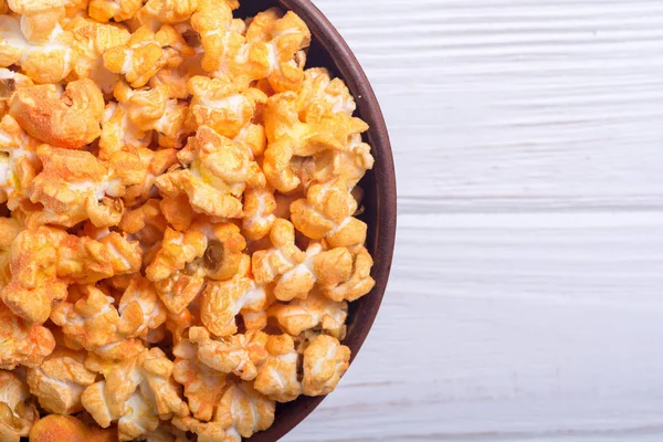 Yellow cheese popcorn in bowl . Snack for cinema