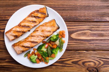 Bir tabakta sebze ile ızgara somon balık. Deniz ürünleri