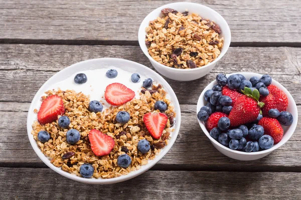 Yogurt with granola and berries  ( blueberries and strawberry )