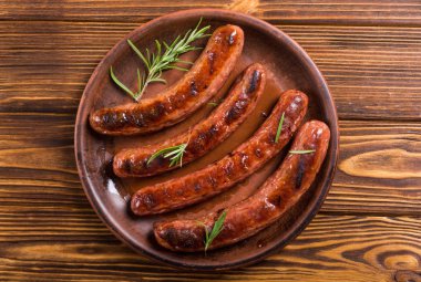 Bir plaka üzerinde ızgara sauusages. Sağlıksız yiyecek arka plan. Barbekü