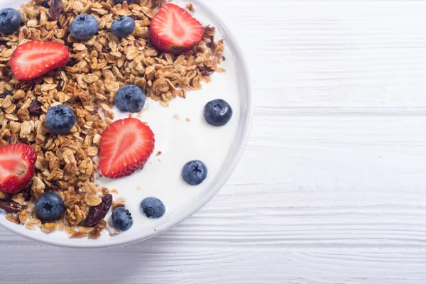 stock image Yogurt with granola and berries  ( blueberries and strawberry )