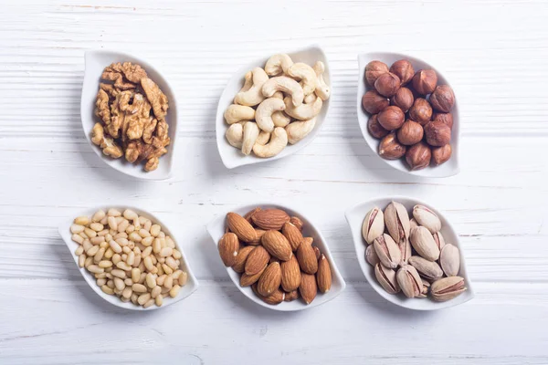 Mix of nuts : Pistachios, almonds , walnuts , pine nut , hazelnuts and cashew . Snack in bowl backgrond