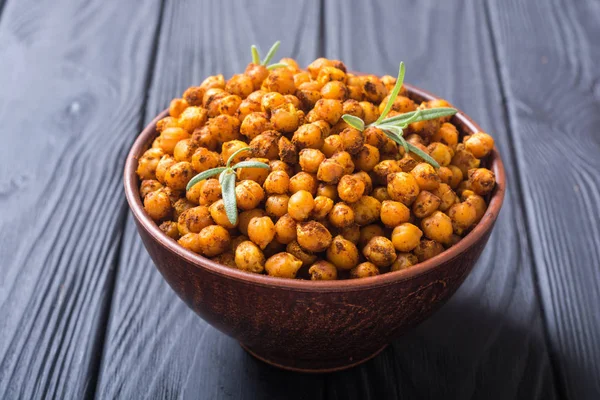 Roasted chickpeas with rosemary . Snack baked food .