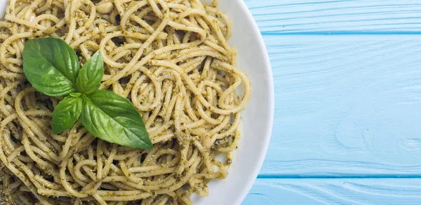 Pasta spaghetti with sauce pesto . Italian food background