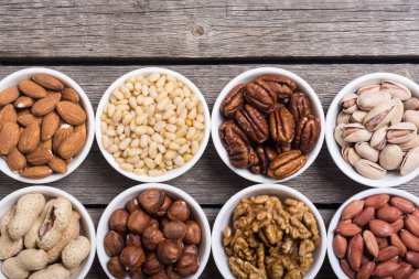 Fındık karışımı: antep fıstığı, badem, ceviz, çam fıstığı, fındık ve kaju. Kase backgrond içinde snack