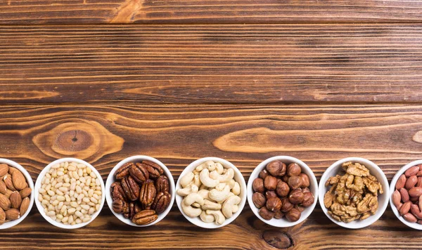 Mix of nuts : Pistachios, almonds , walnuts , pine nut , hazelnuts and cashew . Snack in bowl backgrond