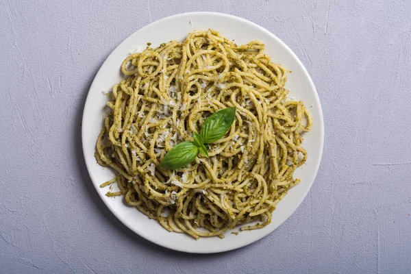 Pasta spaghetti with sauce pesto . Italian food background