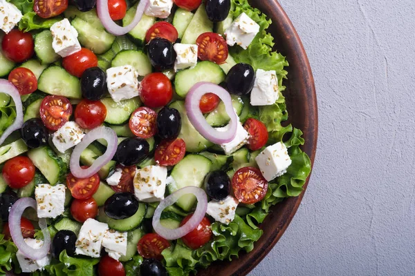 Fresh vegetables greek salad . Healthy food on wooden background