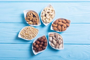 Fındık karışımı: antep fıstığı, badem, ceviz, çam fıstığı, fındık ve kaju. Kase backgrond içinde snack