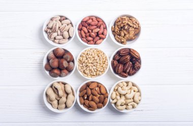 Fındık karışımı: antep fıstığı, badem, ceviz, çam fıstığı, fındık ve kaju. Kase backgrond içinde snack