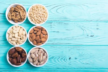 Fındık karışımı: antep fıstığı, badem, ceviz, çam fıstığı, fındık ve kaju. Kase backgrond içinde snack