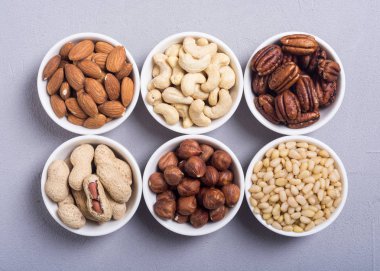 Fındık karışımı: antep fıstığı, badem, ceviz, çam fıstığı, fındık ve kaju. Kase backgrond içinde snack