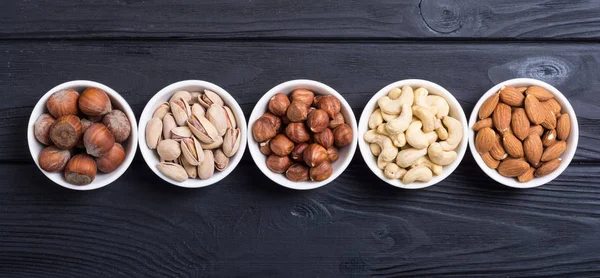 Mix of nuts : Pistachios, almonds , walnuts , pine nut , hazelnuts and cashew . Snack in bowl backgrond