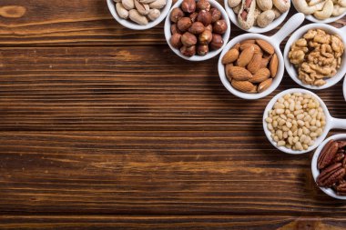 Fındık karışımı: antep fıstığı, badem, ceviz, çam fıstığı, fındık ve kaju. Kase backgrond içinde snack