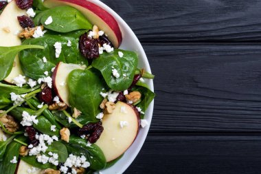 Elma, peynir, ceviz ve kurutulmuş kızılcık sonbahar ıspanak salatası. Sağlıklı vejetaryen yemek