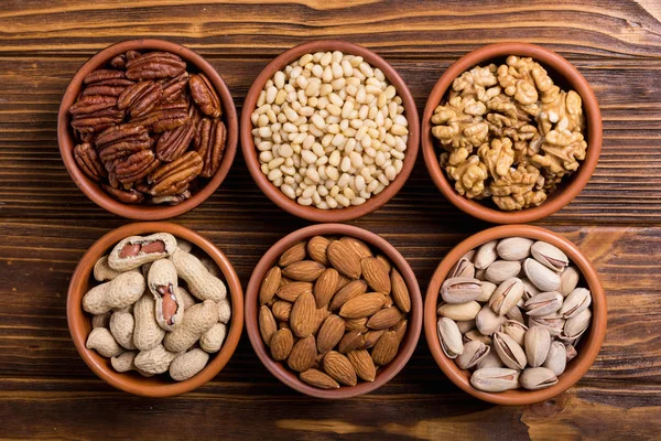 Mix of nuts : Pistachios, almonds , walnuts , pine nut , hazelnuts and cashew . Snack in bowl backgrond