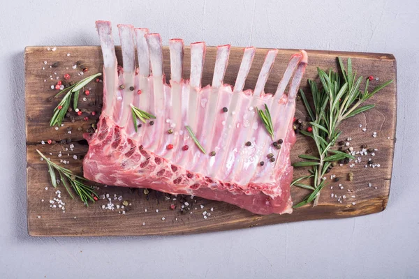 Raw rack of lamb with spices and herbs . Food background