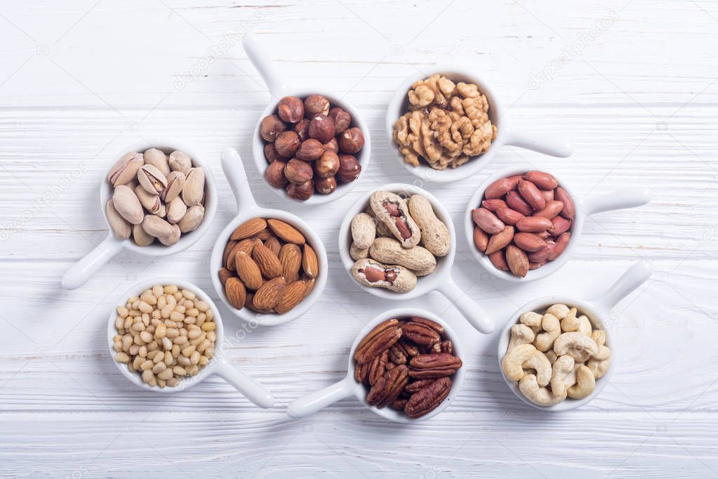 Mix of nuts : Pistachios, almonds , walnuts , pine nut , hazelnuts and cashew . Snack in bowl backgrond