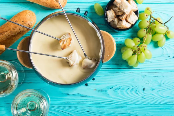 Cheese fondue with bread wine and grape