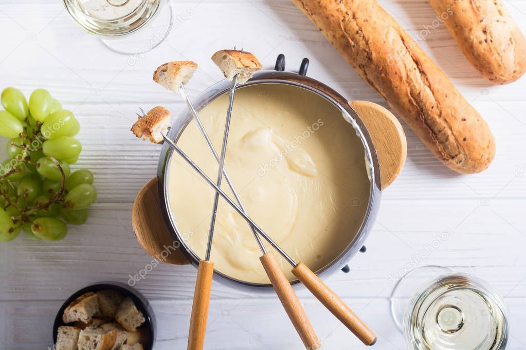 Cheese fondue with bread wine and grape 