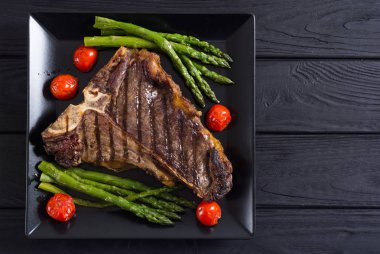 Kuşkonmaz ve kiraz domates ile ızgara T-kemik biftek 